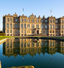view of Longleat House, with reflection in fountain