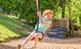 Child plays on zipline
