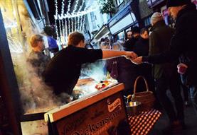 Food being served at a Christmas market stall