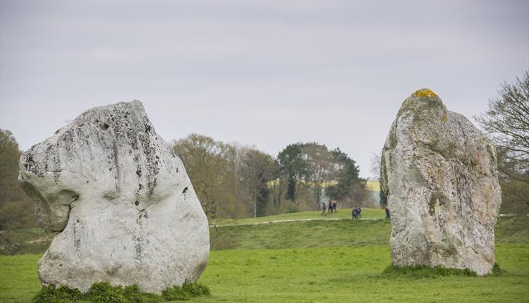 Walkers amongst the Avebury Stone Circle Walkers amongst the Avebury Stone Circle