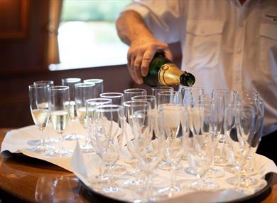 Windsor & Maidenhead Boat Company crew pouring Champagne
