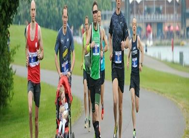 Group running with pushchair by Dorney Lake