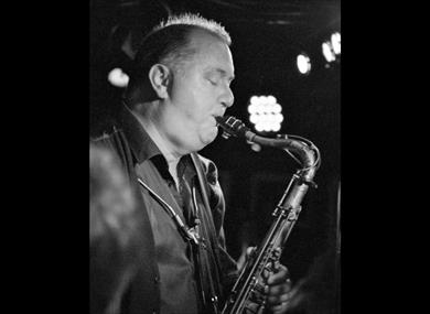 Frank Griffith playing sax in black and white