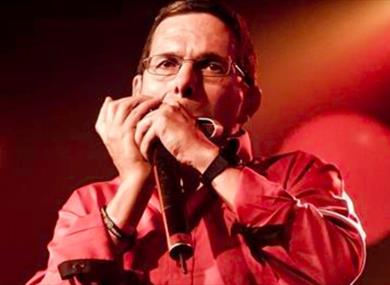 Adam Glasser performing on harmonica