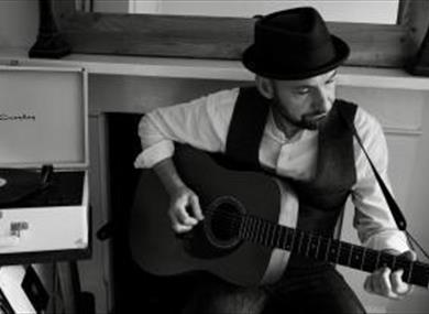 Richard Anderson playing guitar