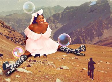 Giant Sophie Duker sat on a mountainside