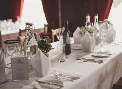 Table with wine, plates and cutlery
