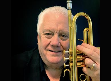 Bruce Adams - holding a trumpet