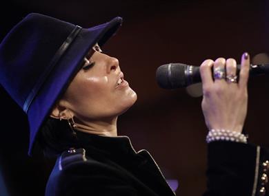 Jo Harrop singing into a microphone