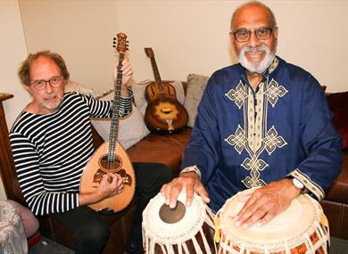 Mark and Iqbal posing with instruments