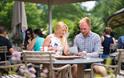 Visitors looking at the menu on the terrace of The Savill Garden Kitchen