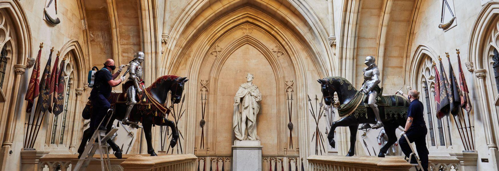 Members of staff at Windsor Castle dust the suits of armour that flank the Grand Staircase in preparation for the Castle’s reopening to visitors on 17 May.