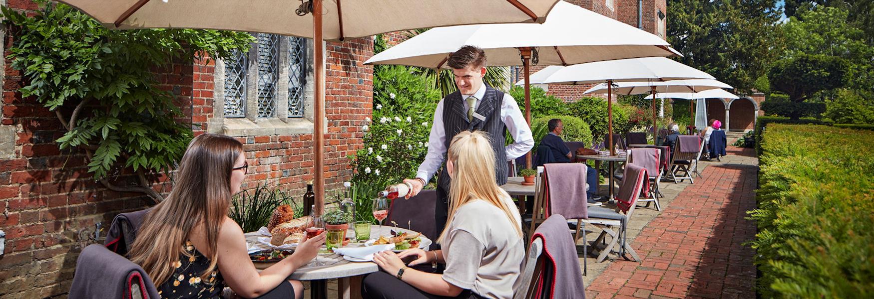 Dining on the terrace at Great Fosters