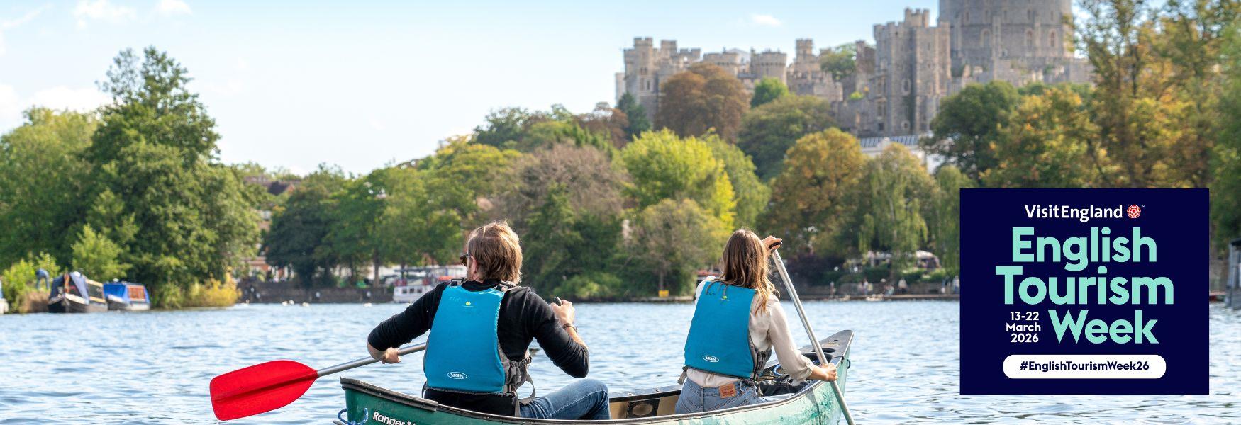 two people canoeing on the River Thames with Windsor Castle in the distance