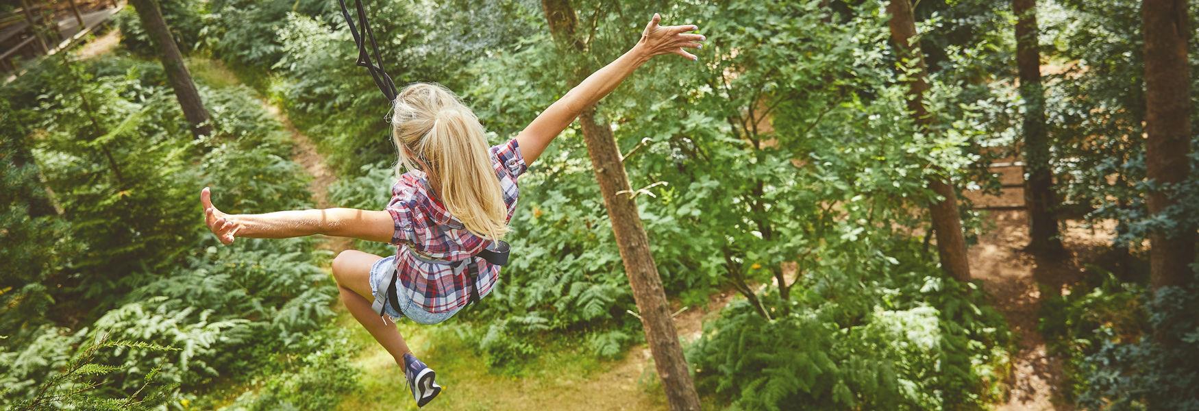 Girl flying down the zipline at Go Ape