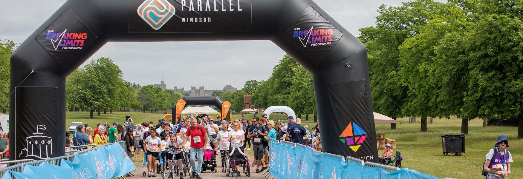 People taking part in Parallel Windsor on the Long Walk with Windsor Castle in the background