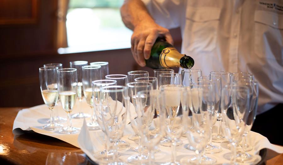 Windsor & Maidenhead Boat Company crew pouring Champagne