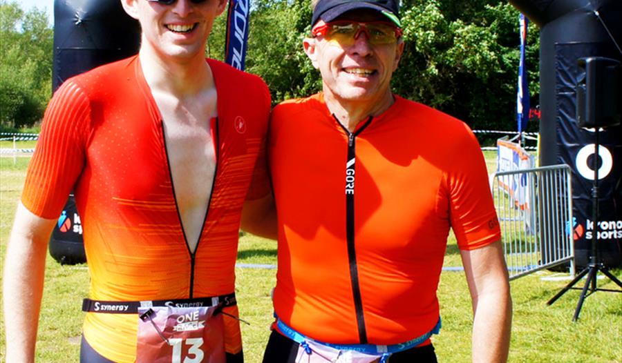 Two triathletes at finish line