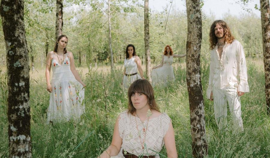 Bryony Dunn and the Forest - band in traditional white clothing out in the woods