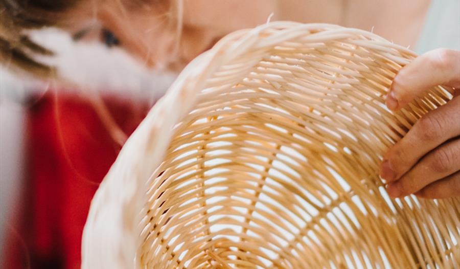 A woman weaving baskets - Cane Basket Weaving BBOWT