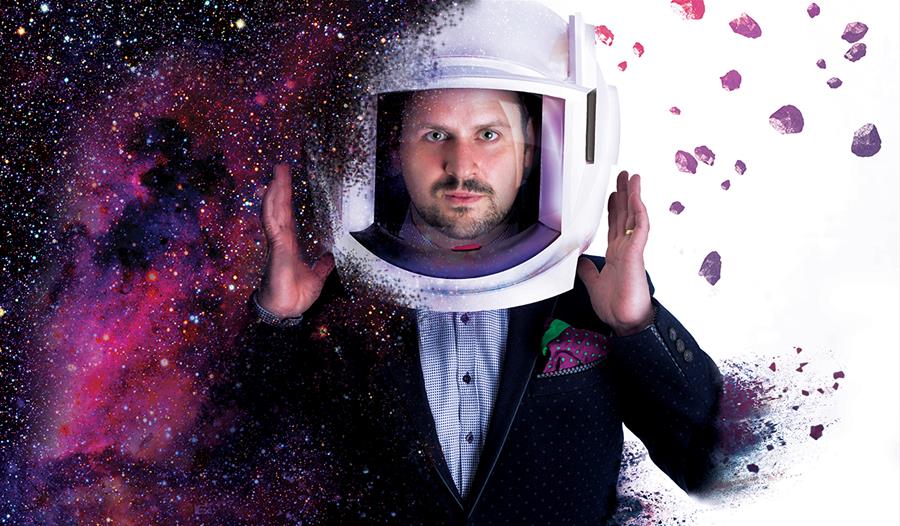 Kevin Quantum Anti-Gravity - man in normal suit, with a astronaut's helmet