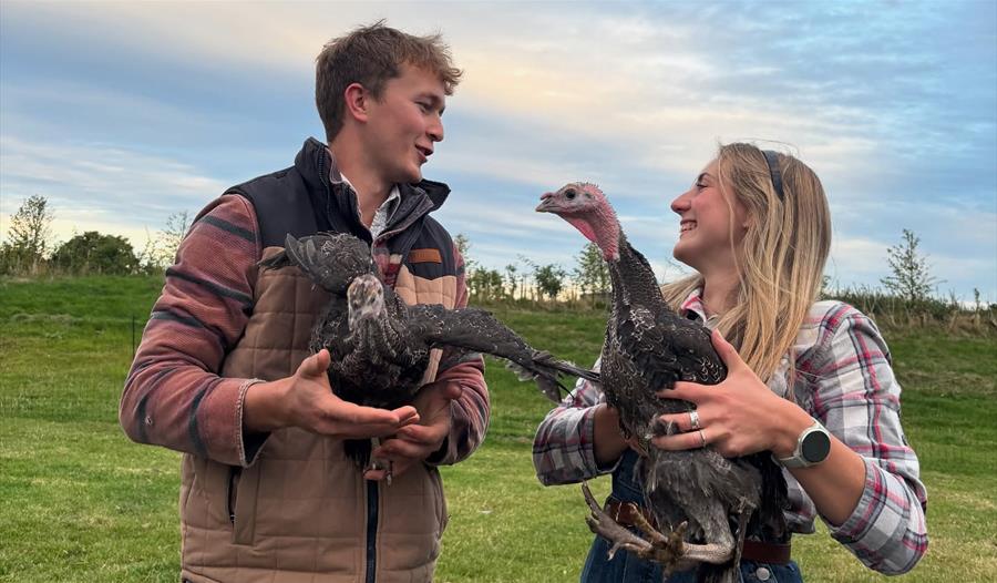 Ollie and Lauren holding turkeys