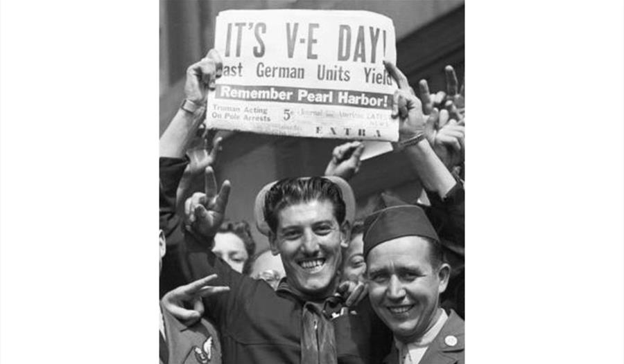 VE Day Tea Party at The Old Court - man holding paper above head