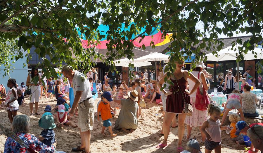 Children, adults and families enjoying the Maidenhead Beach at Norden Farm