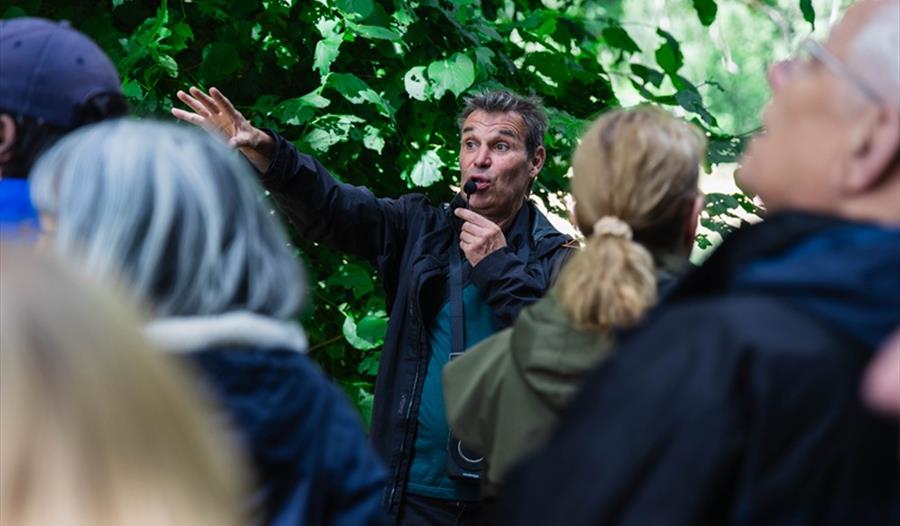 Julian talking to a group amongst the trees