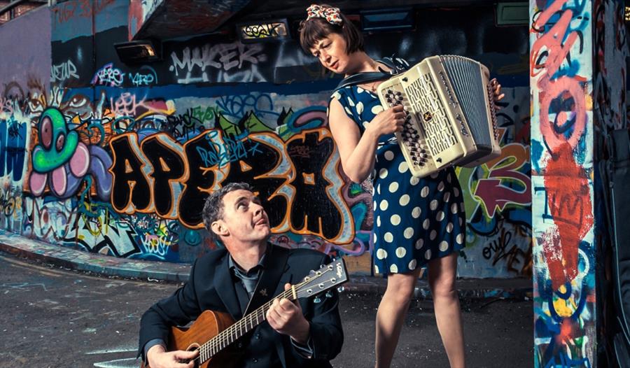 Oh la la! - Accordion and guitarist performing in an urban landscape