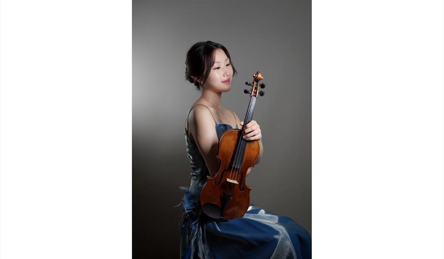Yume Tomita ©Kan Tomita - sat in evening gown holding violin