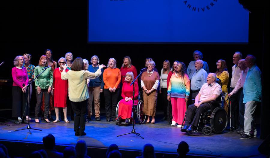 People performing on stage at Norden Farm
