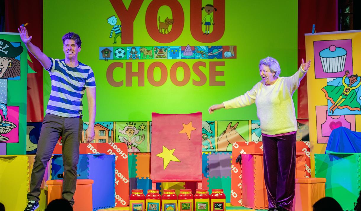 You Choose - performers on stage with bright props and background