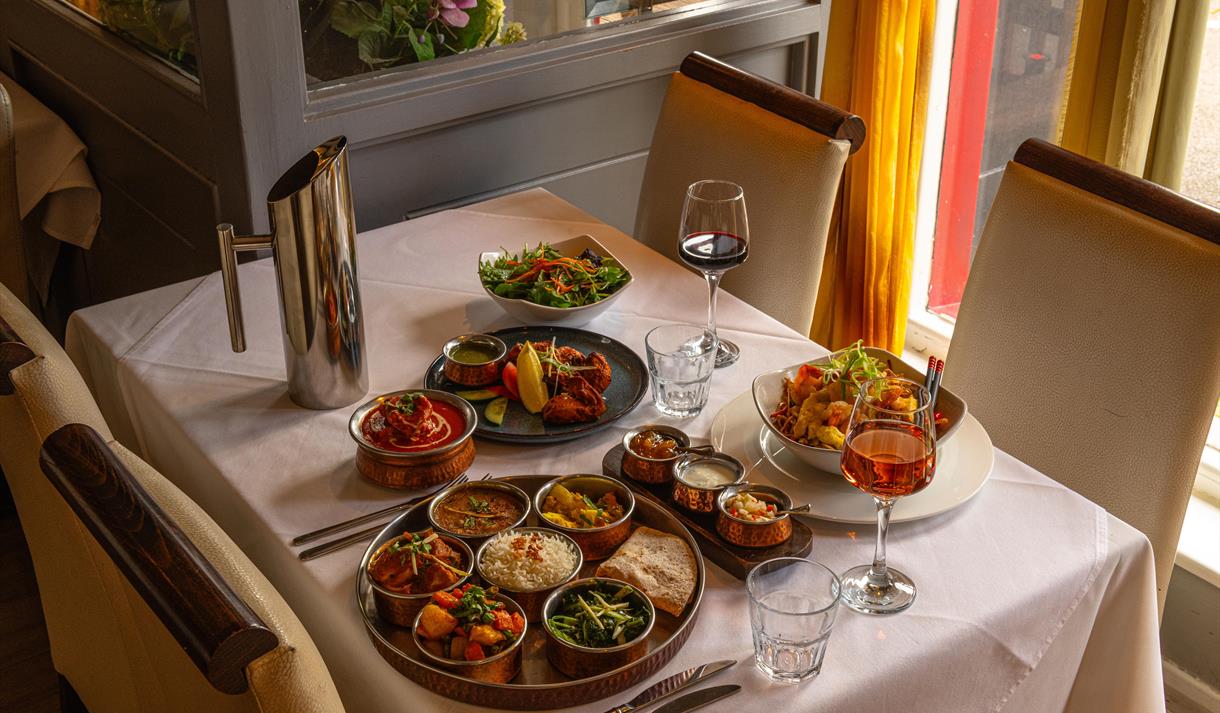 An oriental dinner feast for two, complete with two glasses of wine