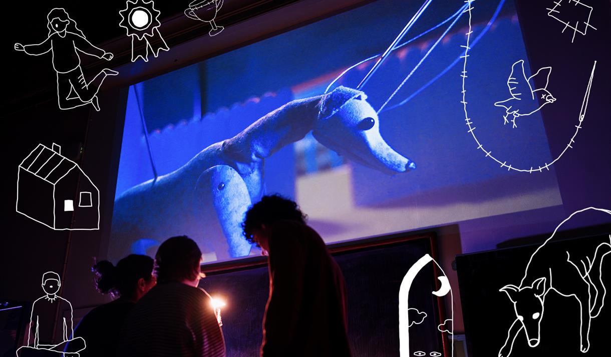 Bark Bark - people in front of a projection of a puppet dog, with doddles around the image