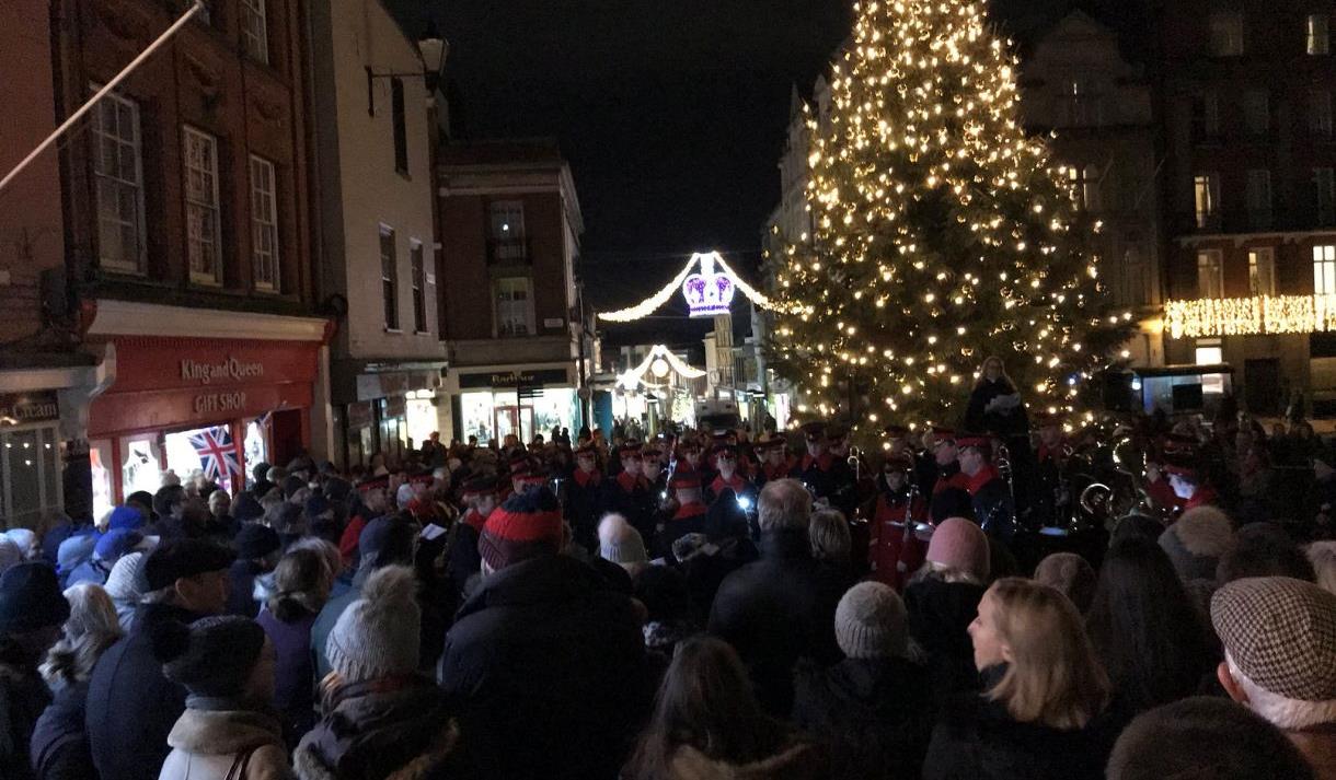 Carols on the Hill - crowd singing around the Christmas tree and with military band, Christmas lights in background