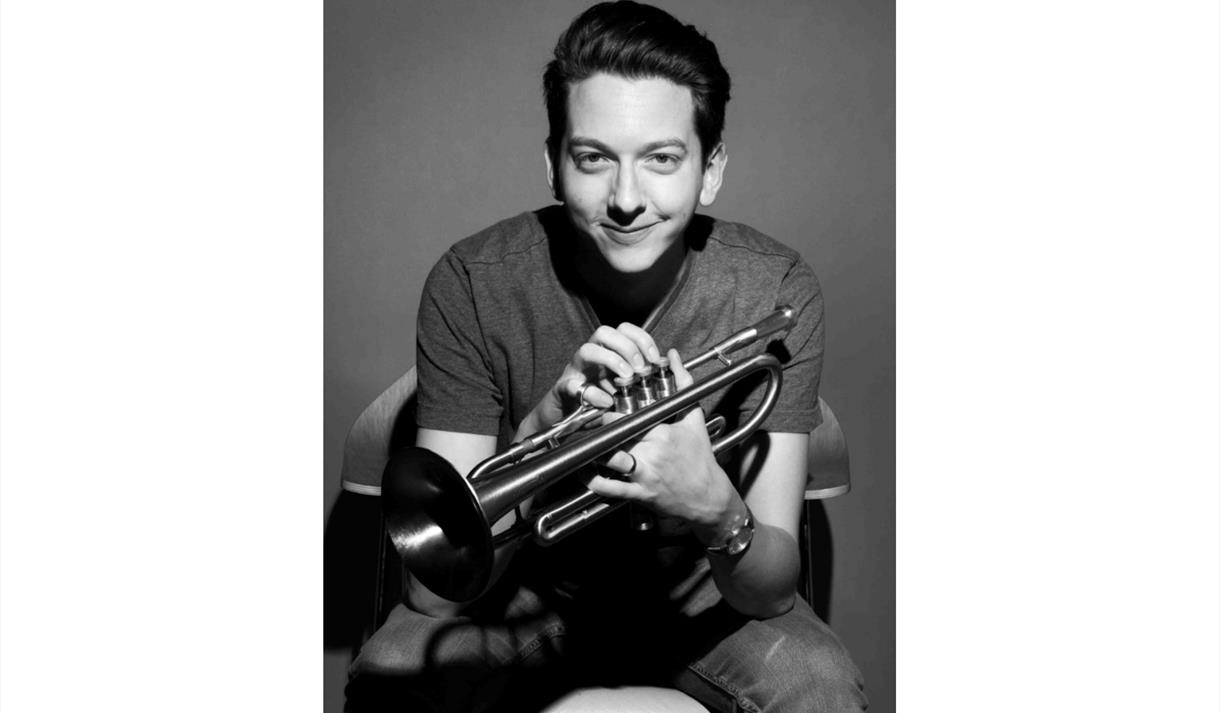 Freddie Gavita, black and white photo holding a trumpet