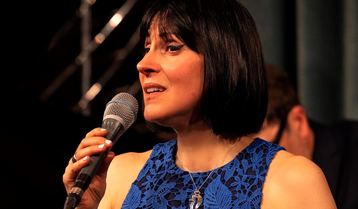 Georgia Mancio singing in a blue dress © Tatiana Gorilovksy