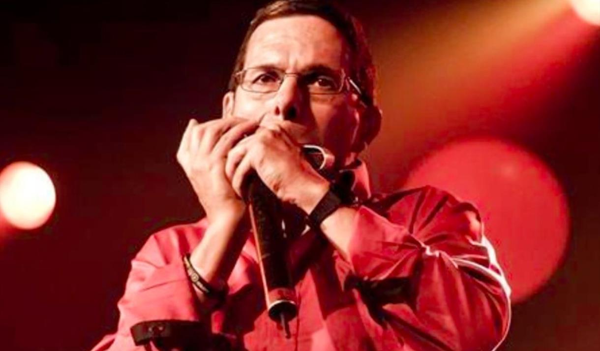 Adam Glasser performing on harmonica