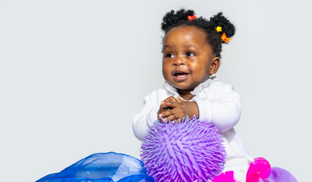 Soft or Spiky - Young girl playing with toys and cloth - ©Steve Gregson