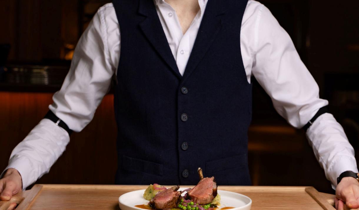 Waiter holding a tray of food