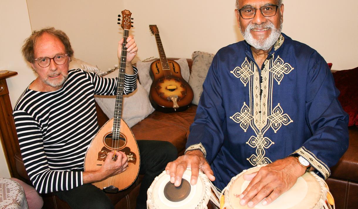 Mark and Iqbal posing with instruments