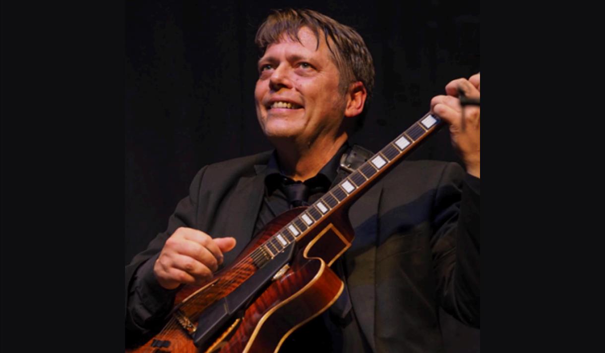 Nigel Price playing guitar
