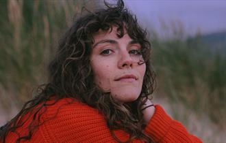 Ellie Gowers - at the beach, red jumper - ©Emilie Cotterill Hires