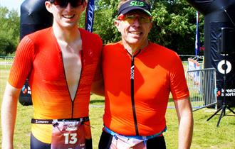 Two triathletes at finish line