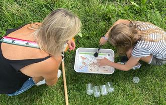 Minibeast Safari, woman and child searching for bugs