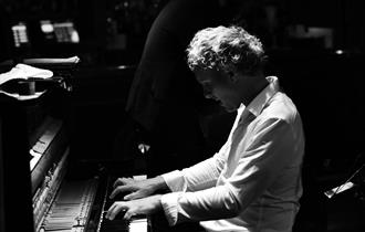 Alex Hutton - Playing piano, black and white