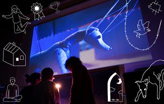 Bark Bark - people in front of a projection of a puppet dog, with doddles around the image