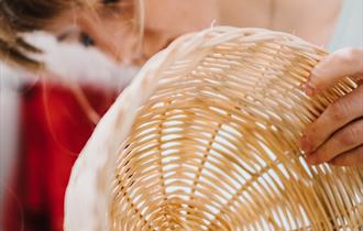 A woman weaving baskets - Cane Basket Weaving BBOWT