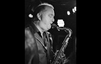 Frank Griffith playing sax in black and white